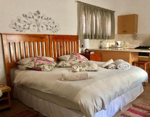 a bedroom with a large bed with towels on it at La Bella B&B Under The Fig Tree in Bela-Bela