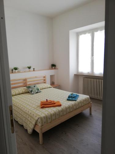 a bedroom with a bed with two towels on it at Affittacamere Badia in Foligno