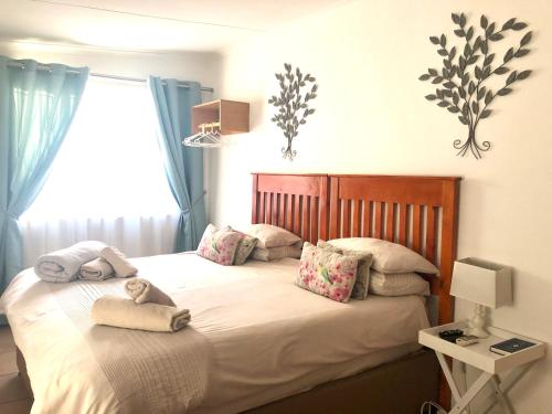 a bedroom with a bed with two pillows on it at La Bella B&B Under The Fig Tree in Bela-Bela