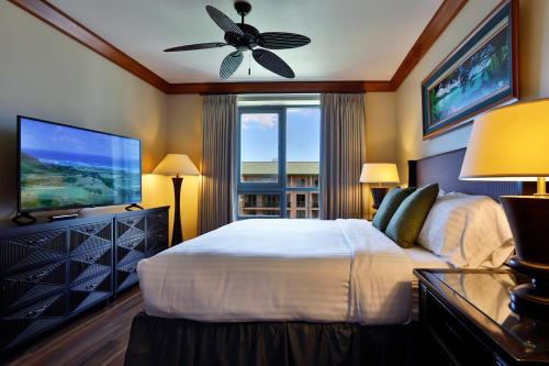 a bedroom with a large bed and a television at Honua Kai - Hokulani 709 - Best Ocean Views! 2b/2.5b in Kaanapali