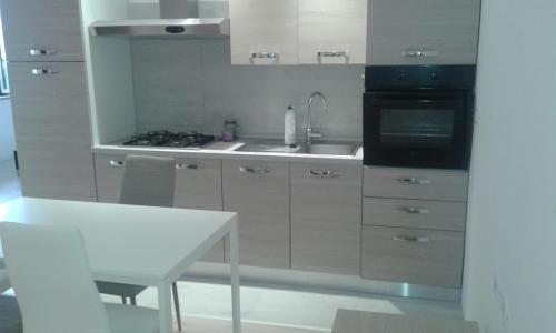 a kitchen with a sink and a stove top oven at VASTO centro Alloggio 1-2-3 in Vasto