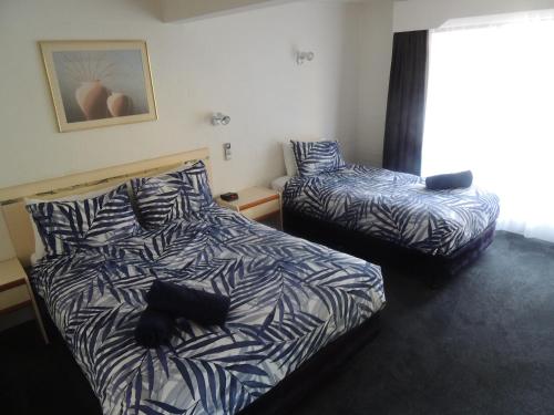 Ένα ή περισσότερα κρεβάτια σε δωμάτιο στο Argyle Terrace Motor Inn