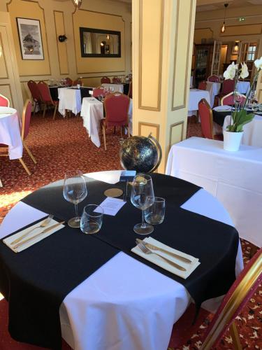 a black and white table with wine glasses on it at Les 3 rois by YY in Villers-Bocage