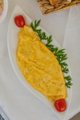 a omelet on a plate with tomatoes on a table at Hotel Concordia in Trogir
