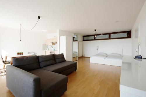 a living room with a couch and a table at Stylisches Penthouse in Karlsruhe -Durlach in Karlsruhe