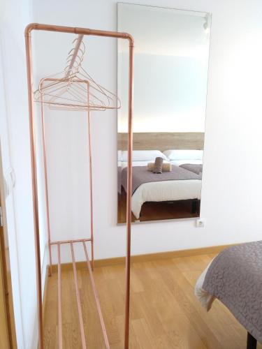 a mirror in a bedroom with a bed in it at PENSION ROSELLA in O Pedrouzo