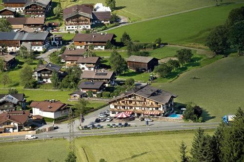 an aerial view of a small village with houses and cars at Ferienhotel Alpenhof in Aurach bei Kitzbuhel