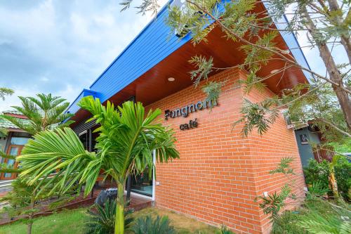 a brick building with a sign that reads dinosaur club at Avarin Resort in Pak Chong