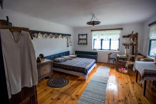 a bedroom with a bed and a wooden floor at Casa din Şona in Şona