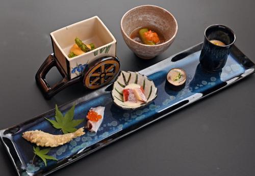 a plate of food with sushi on a table at 原鶴の舞 in Asakura