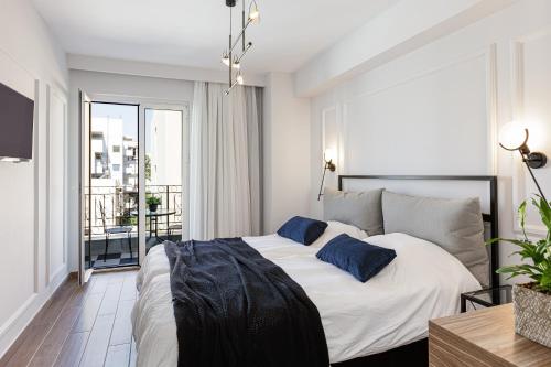 a bedroom with a large bed with blue pillows at Jo An Palace in Rethymno Town