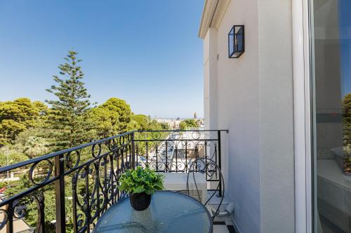 a table with a plant on a balcony at Jo An Palace in Rethymno Town