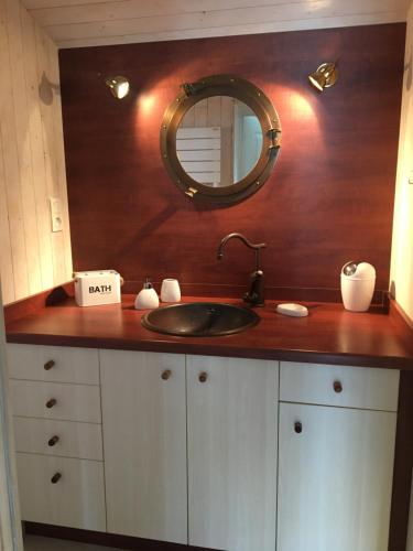 a bathroom counter with a sink and a mirror at Gite LES BALISES- BABORD-Maisons de bord de mer avec spa -SAINT GILLES CROIX DE VIE - 27 Avenue NOTRE DAME in Saint-Gilles-Croix-de-Vie