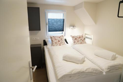 two beds in a small room with a window at Floating vacationhome Tenerife in Maastricht