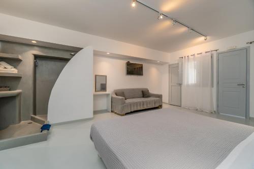 a living room with a bed and a couch at Central Fira Suites in Fira