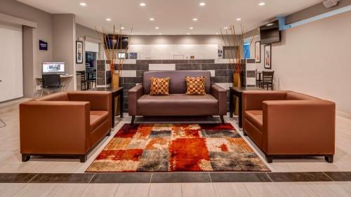 a waiting room with two chairs and a table at SureStay Plus Hotel by Best Western Humble in Humble