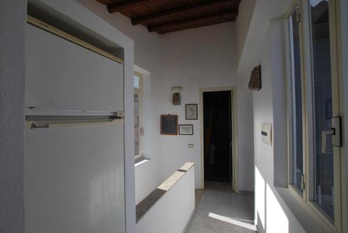 a hallway with white walls and a window at Vulcanoconsult Appartamenti Spiaggia in Lipari