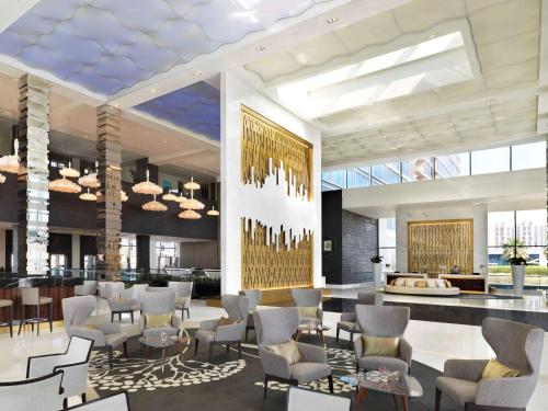 a lobby of a hotel with chairs and tables at Fairmont Bab Al Bahr in Abu Dhabi