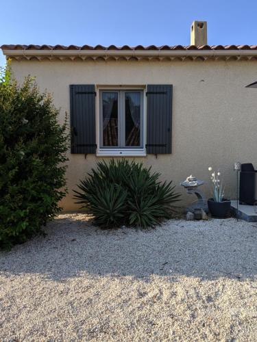 ein Haus mit einem Fenster und Pflanzen davor in der Unterkunft chambre d'hôtes chaleureuse en Drôme Provençale in Valréas