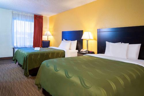 a hotel room with two beds in a room at Quality Inn at Arlington Highlands in Arlington