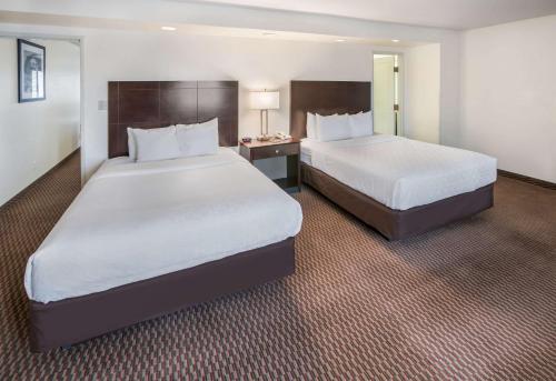 a hotel room with two beds and a desk at Clarion Inn Page - Lake Powell in Page