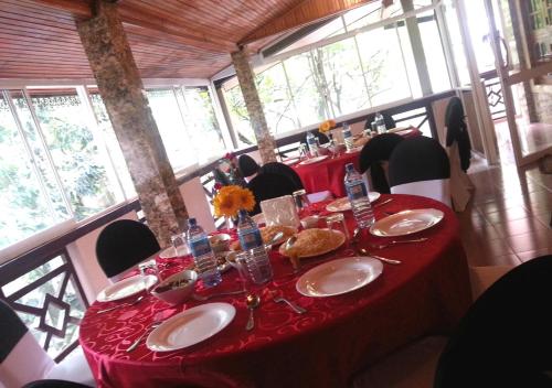 Mawanella的住宿－Mahoya，一张桌子,上面有红色的桌布和盘子