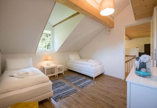 a attic bedroom with a bed and a table at Le Manoir Penthouse in Wengen