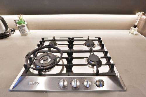 a stove top oven sitting on top of a counter at Box Hill Central Sky One Apartment in Box Hill
