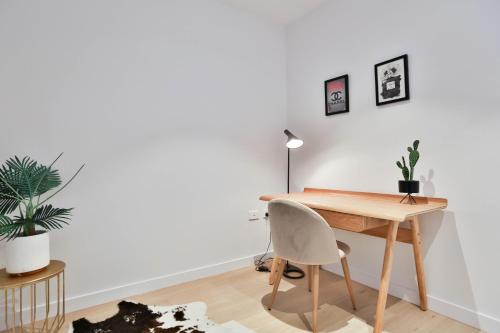 an office with a wooden desk and a chair at Box Hill Central Sky One Apartment in Box Hill