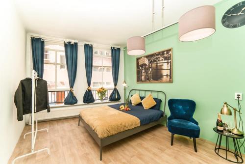 a bedroom with a bed and a blue chair at GreenLuxuryHouse in Amsterdam