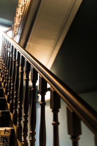 a row of wooden stairs with a rail at Hôtel Vedette in Profondeville