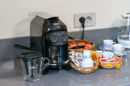 a coffee maker sitting on a counter next to a basket at B&b IL CERE in Alseno