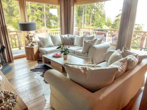 a living room with a couch and a table at Crans Luxury Lodges in Crans-Montana
