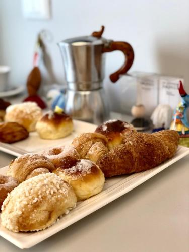 a plate of pastries on a table with a mixer at Relais Villa Montedonzelli in Naples