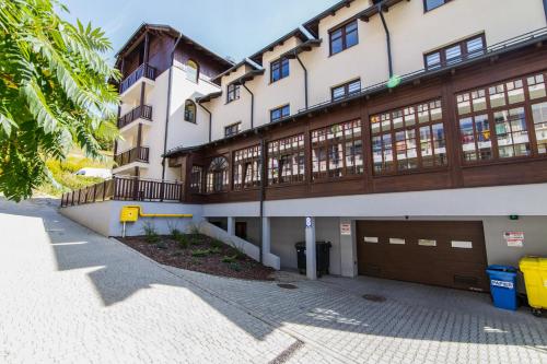 ein Gebäude mit zwei Garagentüren auf der Seite in der Unterkunft Gold Apartments Your Holiday Home RODZINNY 27 in Krynica-Zdrój