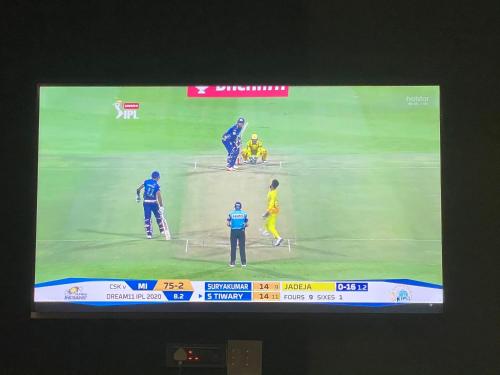 a television screen showing a cricket game at SHAH SOCIAL PARTY VILLA In Royal Palms Mumbai in Mumbai