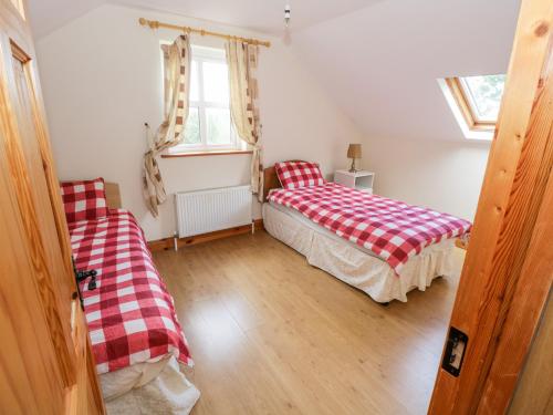 A bed or beds in a room at Lough Mask Road Fishing Cottage