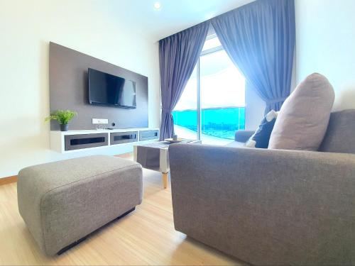 a living room with a couch and a large window at The Wave Suites Melaka in Melaka