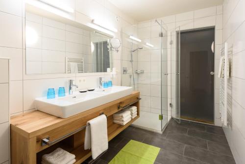 a bathroom with a sink and a shower at Family Apart Stubai in Fulpmes