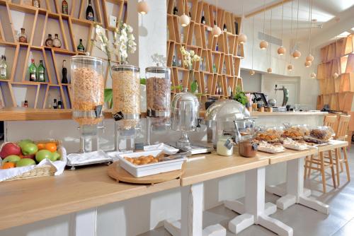 a kitchen with a long counter with food on it at Petinos Beach Hotel in Platis Yialos Mykonos