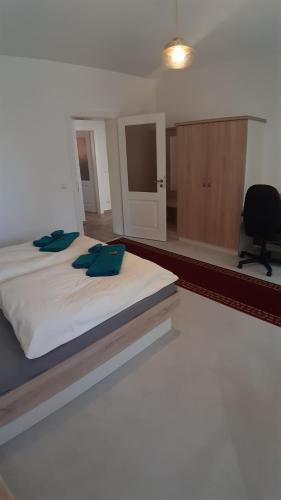 a bedroom with a large bed with a black chair at Haus am Zemminsee in Groß Köris