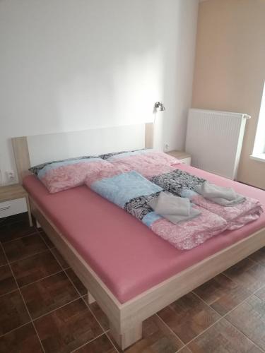 a bed in a room with a pink mattress at Apartmán Žilina in Žilina