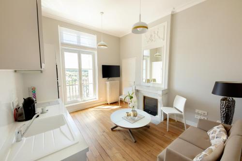 a living room with a couch and a table at Le Rempart du Midi in Angoulême