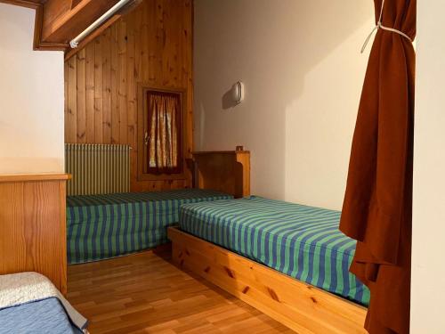 A bed or beds in a room at Residence Tarvisio Camporosso