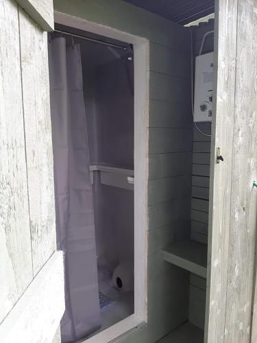 a walk in shower with a purple shower curtain at Cae Mawr Yurt Off-Grid Glamping in Machynlleth
