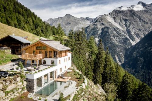 a house on the side of a mountain at Leni Mountain Chalet in Sölden