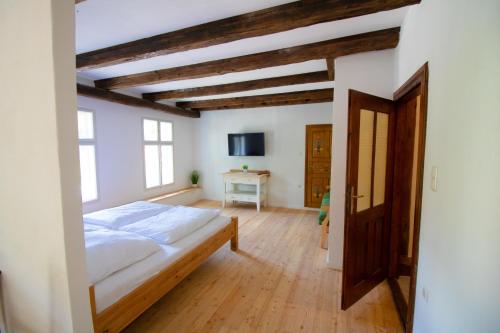 a bedroom with a bed in a room with wooden floors at Villa Hardegg in Hardegg