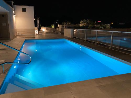 a swimming pool at night with blue illumination at Lagrange Apart'Hôtel Antibes Olympie in Antibes