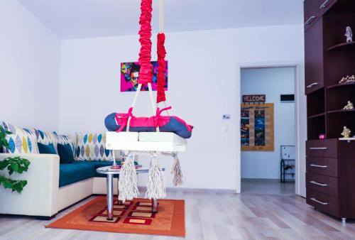 a living room with a blue couch and red ropes at Happy Family in Braşov