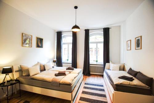 a living room with two beds and a couch at Altstadt-Ferienwohnungen Braunschweig in Braunschweig